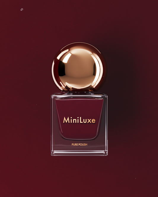 MiniLuxe Pure Polish Crimson red bottle red background